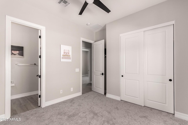 unfurnished bedroom featuring baseboards, connected bathroom, visible vents, and carpet