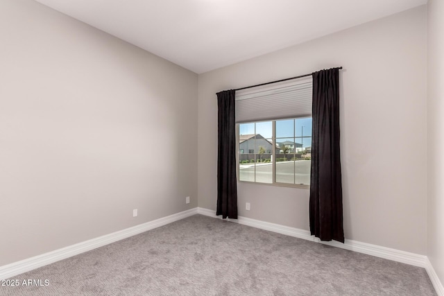 carpeted spare room with baseboards