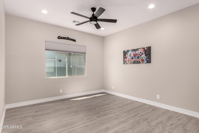 spare room with a ceiling fan, wood finished floors, baseboards, visible vents, and recessed lighting