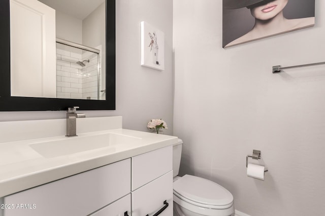 full bathroom featuring a shower with shower door, toilet, and vanity