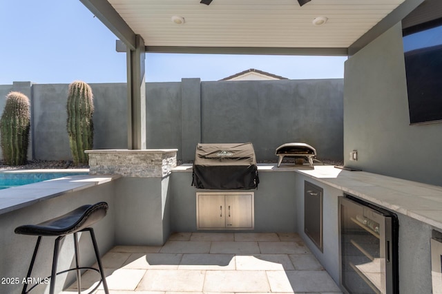 view of patio / terrace with area for grilling and wine cooler