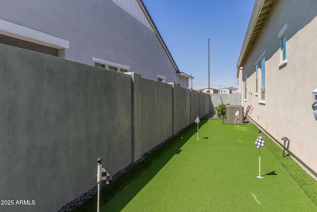 view of yard featuring a fenced backyard and cooling unit