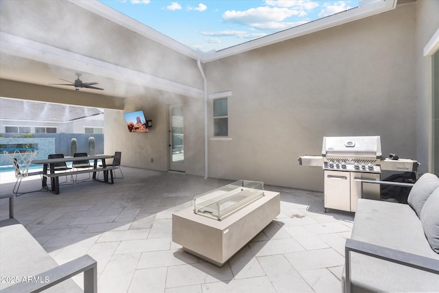 view of patio featuring an outdoor fire pit, a ceiling fan, and a grill