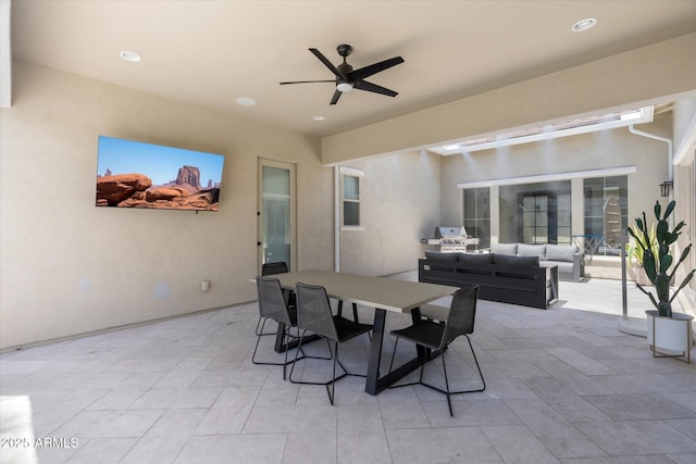 view of patio featuring an outdoor living space, outdoor dining area, and a ceiling fan
