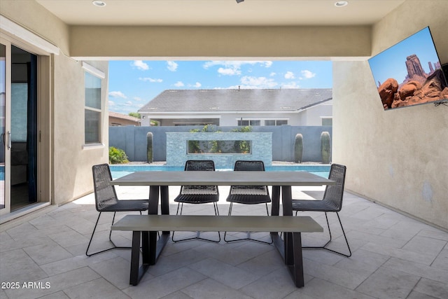 view of patio / terrace featuring outdoor dining area and fence