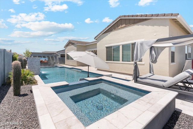 view of swimming pool featuring a fenced backyard, a pool with connected hot tub, and a patio area