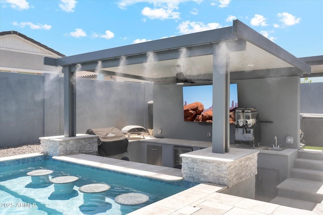 view of patio / terrace with a sink, area for grilling, a ceiling fan, and an outdoor pool