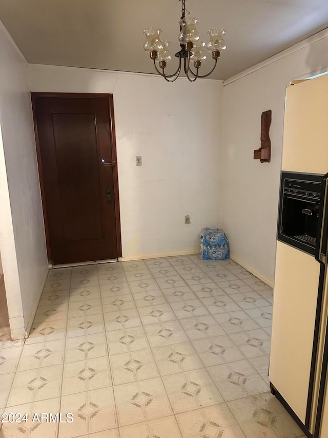 unfurnished dining area with a chandelier