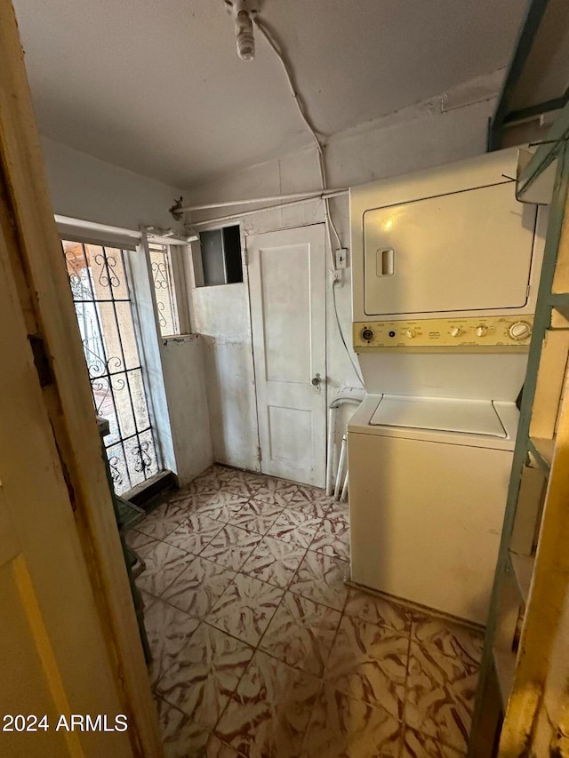 laundry room featuring stacked washer and dryer