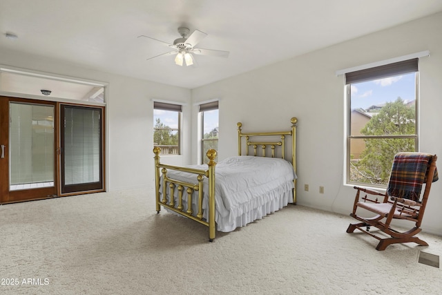 bedroom with carpet floors, ceiling fan, multiple windows, and visible vents