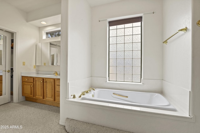 full bathroom featuring a bath and vanity