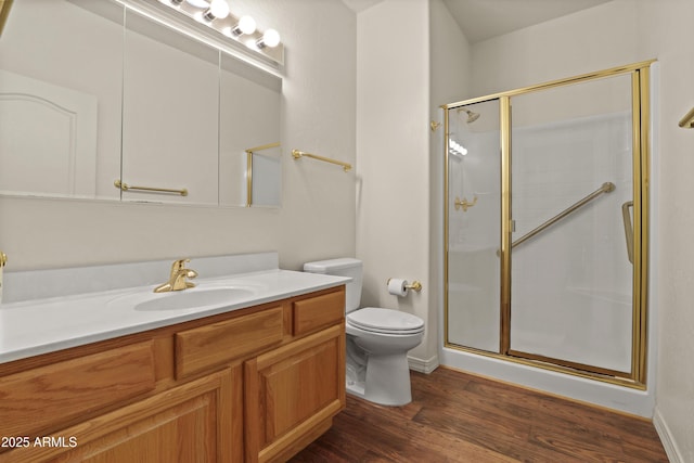 full bath featuring toilet, a stall shower, wood finished floors, and vanity