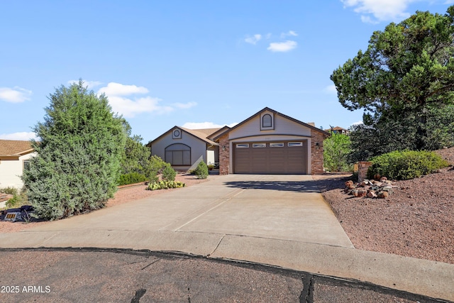 single story home featuring driveway, brick siding, and an attached garage