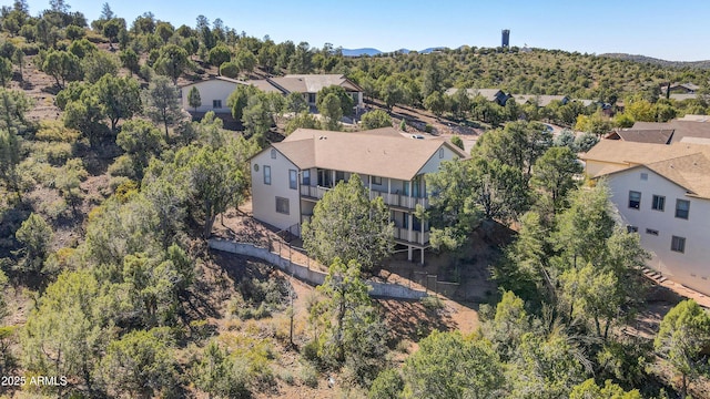 drone / aerial view featuring a wooded view