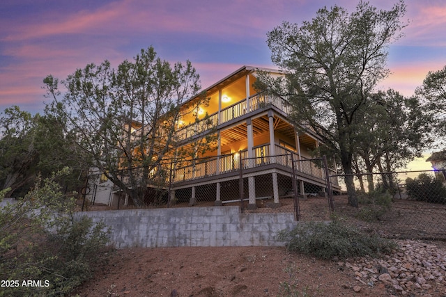 back of property featuring fence and a deck