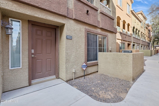 view of exterior entry featuring stucco siding