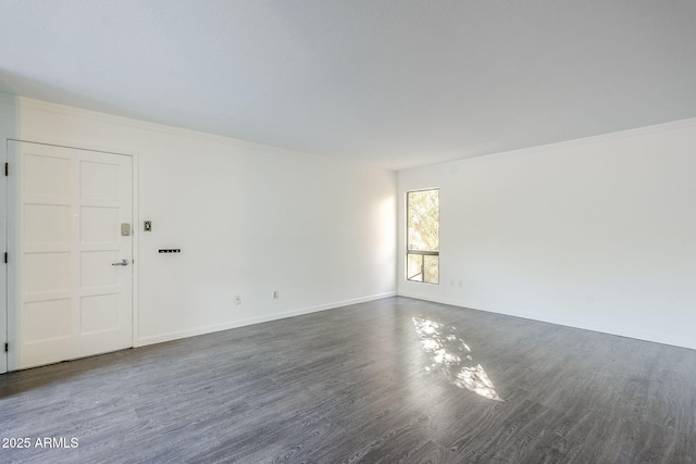 unfurnished room with dark wood-type flooring and crown molding