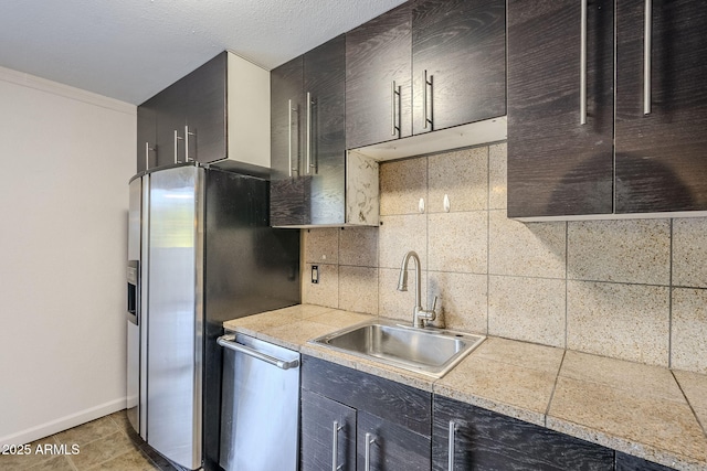 kitchen with sink, appliances with stainless steel finishes, tasteful backsplash, ornamental molding, and tile patterned floors