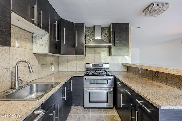 kitchen with wall chimney range hood, decorative backsplash, stainless steel appliances, and sink