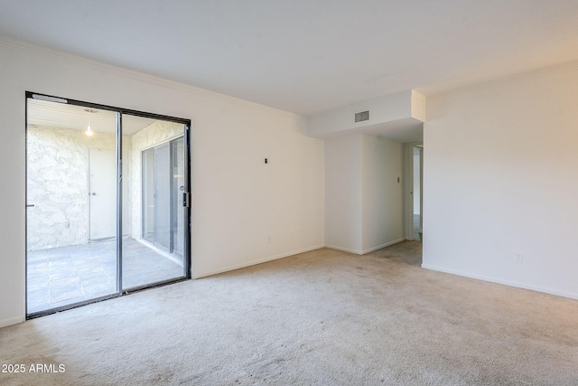 unfurnished room featuring ornamental molding and light colored carpet