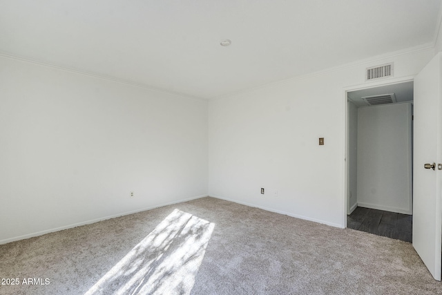 carpeted empty room featuring ornamental molding