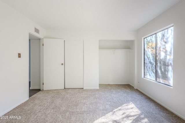 unfurnished bedroom with multiple windows, crown molding, and carpet flooring