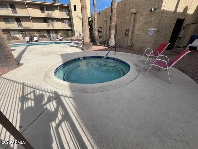 view of swimming pool with a community hot tub