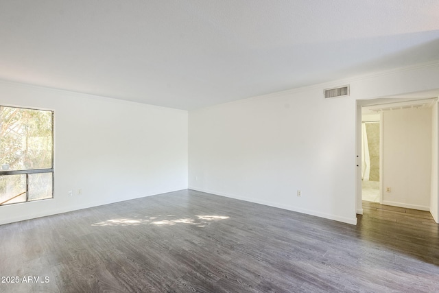 unfurnished room with crown molding and dark hardwood / wood-style floors