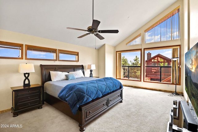 carpeted bedroom with ceiling fan and high vaulted ceiling