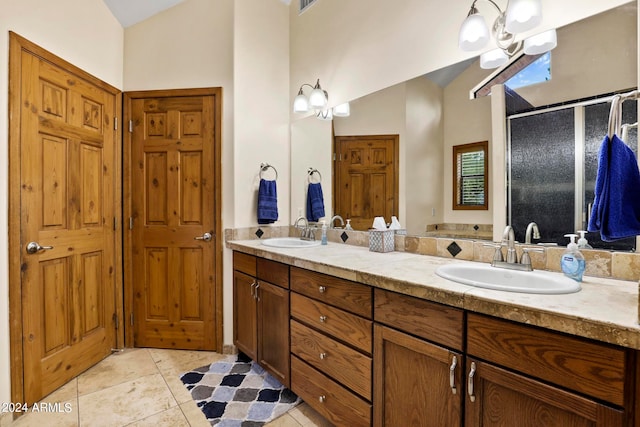 bathroom featuring a shower with door, vanity, and tile patterned floors