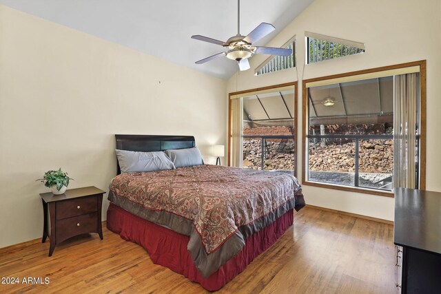 bedroom featuring ceiling fan, high vaulted ceiling, and light hardwood / wood-style floors