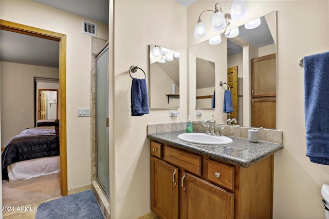 bathroom featuring vanity and a shower with shower door