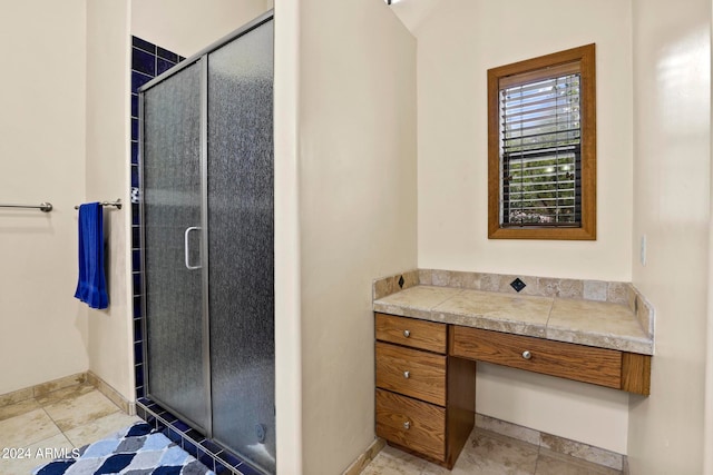 bathroom featuring tile patterned flooring and an enclosed shower