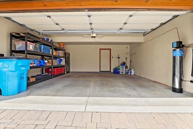 garage featuring washing machine and dryer and a garage door opener