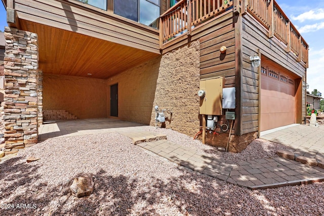 exterior space featuring a balcony and a garage