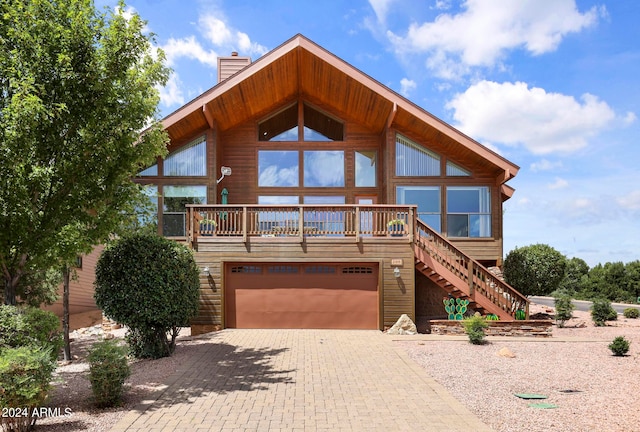 log-style house with a garage