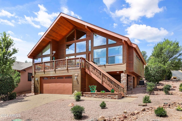 view of front of house featuring a garage and central AC