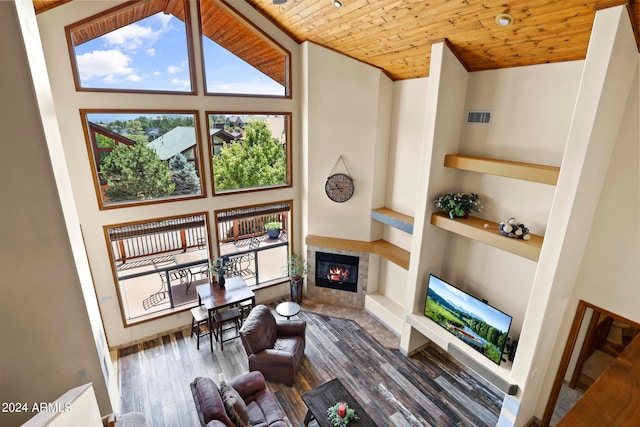 living room featuring high vaulted ceiling, wood ceiling, dark wood-type flooring, and a fireplace