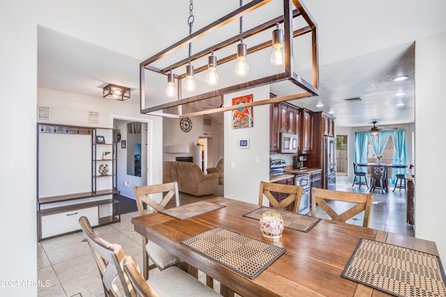 tiled dining area with ceiling fan