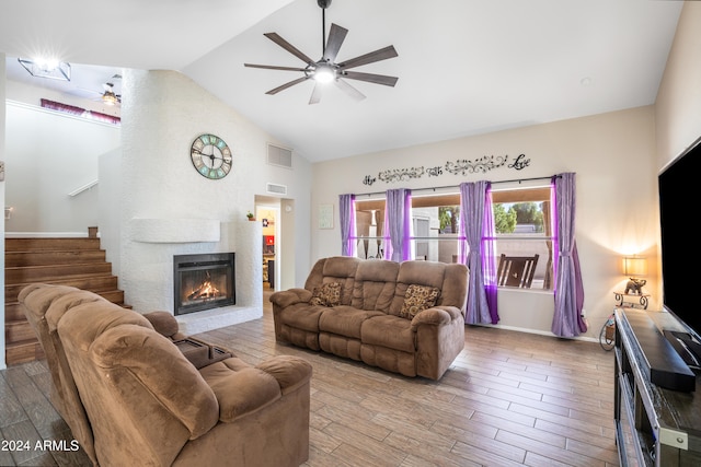 living room with hardwood / wood-style floors, ceiling fan, and high vaulted ceiling