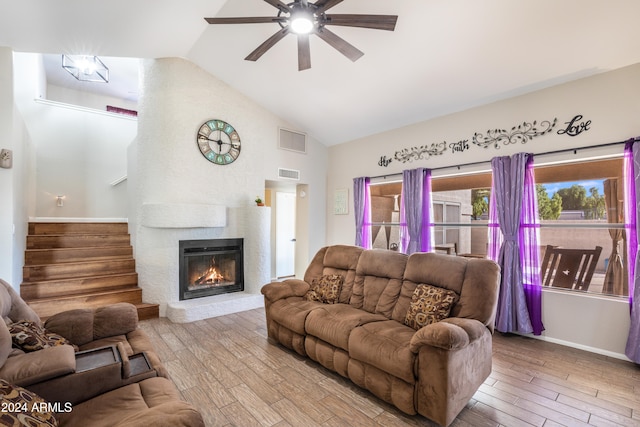 living room featuring hardwood / wood-style flooring, ceiling fan, and high vaulted ceiling