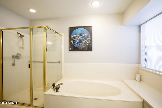 bathroom featuring separate shower and tub and plenty of natural light