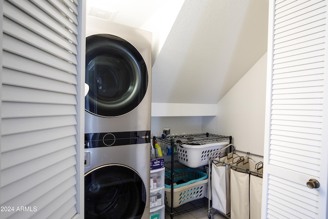 clothes washing area with stacked washer and clothes dryer