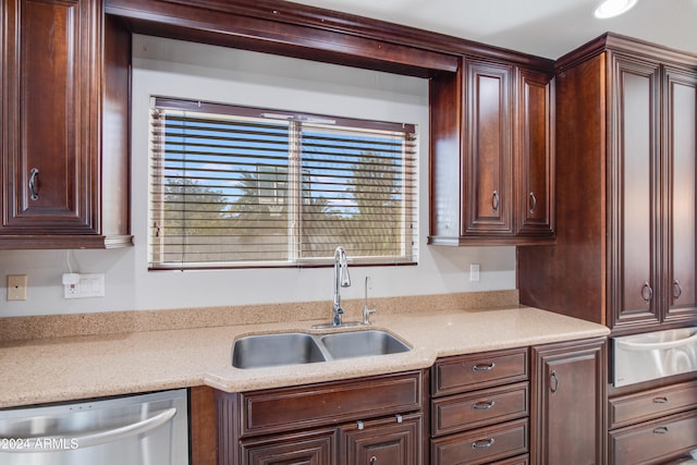 kitchen featuring stainless steel dishwasher, sink, and a wealth of natural light