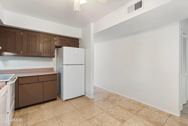 kitchen with dark brown cabinetry, white appliances, ceiling fan, and light tile patterned flooring