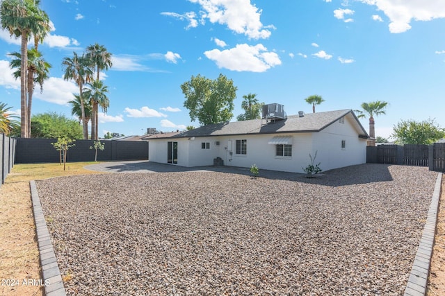 rear view of property featuring cooling unit and a patio