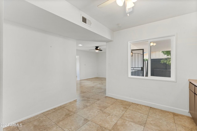 spare room with light tile patterned floors and ceiling fan