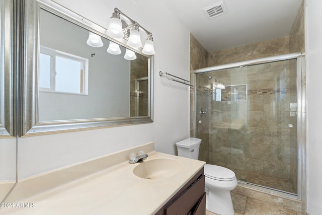 bathroom featuring tile patterned flooring, vanity, toilet, and an enclosed shower