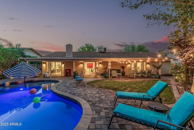11822 S Coconino St, Phoenix, AZ 85044 - back of house with a chimney, a patio area, and an outdoor pool
