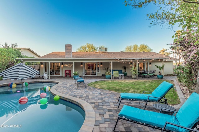 11822 S Coconino St, Phoenix, AZ 85044 - back of property featuring a chimney, a patio, an outdoor pool, and french doors